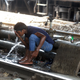 A man washes himself at a water pipe to cool down along the railway tracks in New Delhi.